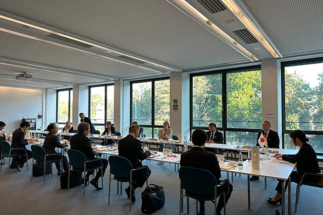 View into the meeting room with many participants