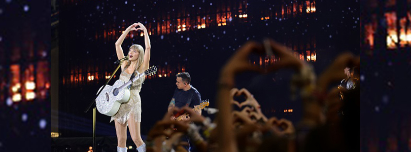 Taylor Swift with guitar on stage