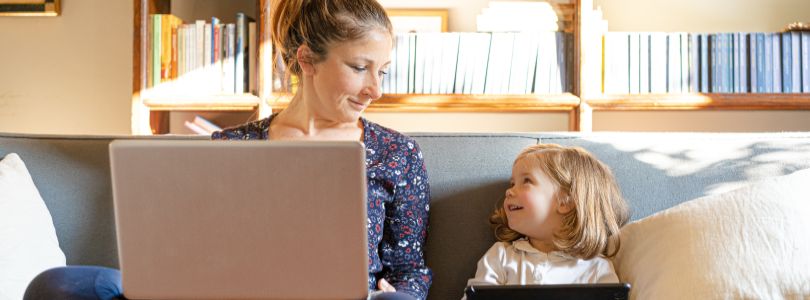 Mutter und Tochter auf Sofa mit Computer