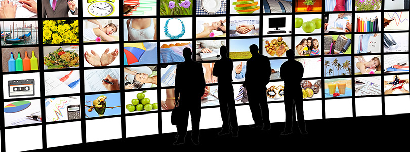 Large display wall with various picture watched by four people