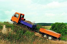 Transportfahrzeug mit Anhänger fährt Steigung